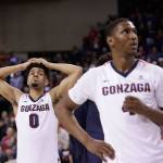 Gonzaga guards Silas Melson (left) and Jordan Mathews (right) stand on the court during senior night speeches after Gonzaga&rsquo;s 79-71 loss to BYU in Spokane, Washington on Saturday. (AP Photo/Young Kwak)