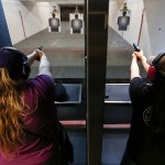 Jessica Belmont (left), of Woodinville, and Brianna Badger, of Arlington, practice their accuracy during a get-together with members of Snohomish County&rsquo;s chapter of The Well Armed Woman at the Norpoint Shooting Center in Arlington on Saturday, Feb. 4. (Ian Terry / The Herald)