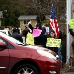 Neighbors of the Evergreen Islamic Insititue &mdash; many of them from area churches &mdash; express support and love to Muslims arriving at the Lynnwood mosque. (Dan Bates / The Herald)