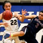 Lynnwood&rsquo;s Kaprice Boston (left) and Mt. Spokane&rsquo;s Jaidyn Lyman vie for a loose ball during a regional playoff game Feb. 25, 2017, at Bothell High School. Lynnwood won 57-46. (Kevin Clark / The Herald)