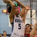Meadowdale&rsquo;s Xavier Meekins attempts a shot over Snohomish&rsquo;s Kolton Smith during a 3A district play-in game on Feb. 10, 2017, at Meadowdale High School in Lynnwood. The Mavericks won 66-54. (Kevin Clark / The Herald)