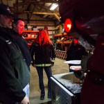 Oso fire Capt. Tim Harper, chaplain and firefighter Joel Johnson and firefighter Cyndy Olson inspect a newly repaired firetruck at the station on Highway 530 in Oso on Tuesday. (Daniella Beccaria / The Herald)