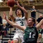 Shorecrest&rsquo;s Malcolm Rosier-Butler attempts a shot with Edmonds-Woodway&rsquo;s Noah Becker defending during a state regional playoff game on Feb. 25, 2017, at Bothell High School. Shorecrest won 74-63. (Kevin Clark / The Herald)