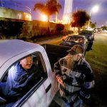 Workers line up on the street to find out if they&rsquo;ll get a shift at the ports. This ritual is repeated every morning for casual longshoremen and women. (Mark Boster / Los Angeles Times)