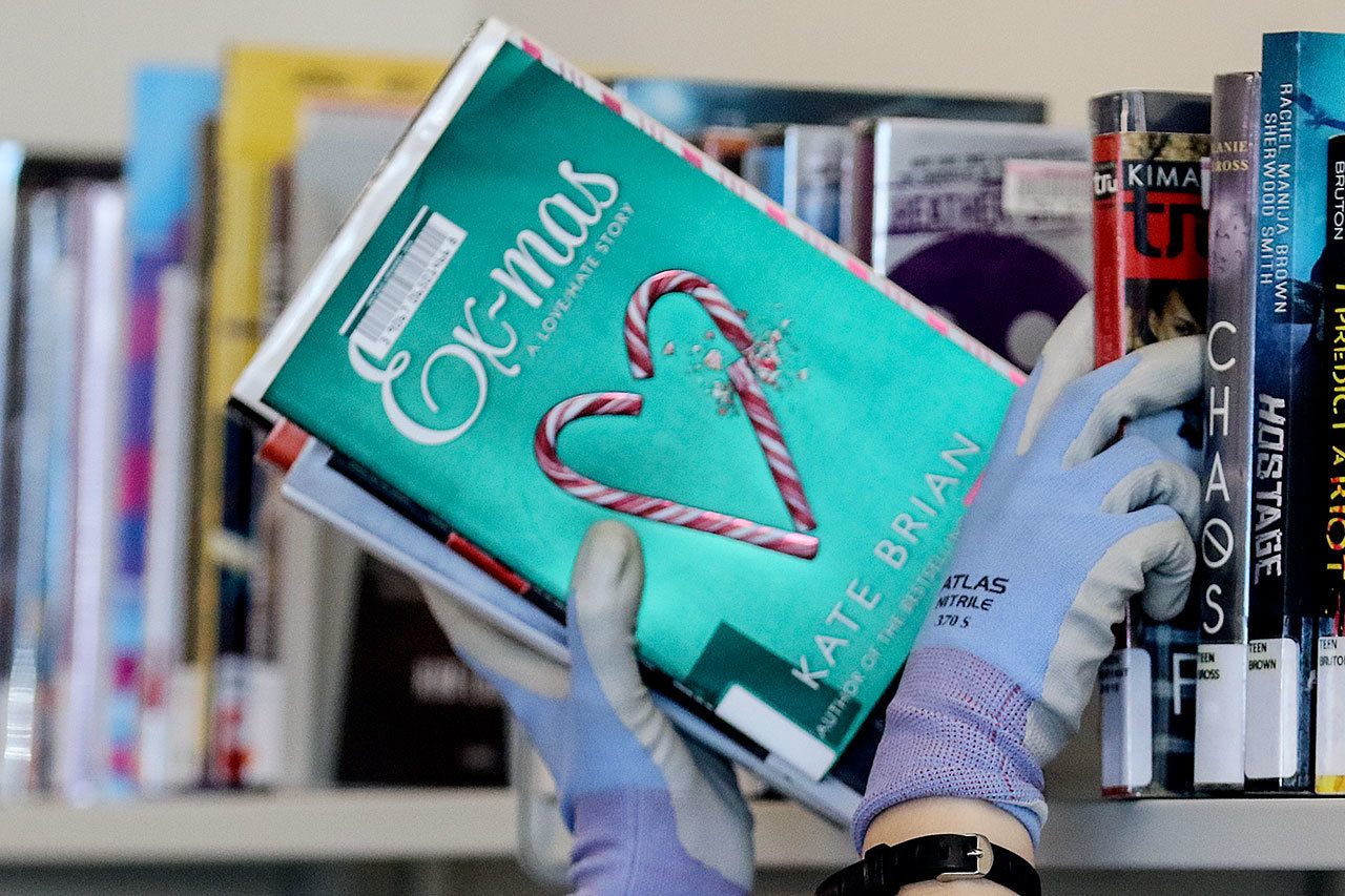 Books are stocked at the new Mariner Library in Everett on Feb. 2. The demonstration community library will carry more than 16,000 titles and will open Saturday. (Kevin Clark / The Herald)