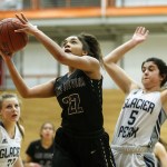 Lake Stevens&rsquo; Raigan Reed (22) goes to the hoop as she&rsquo;s pursued by Glacier Peak&rsquo;s Samantha Fatkin (5) during the Class 4A District 1 girls basketball championship game at Everett Community College on Thursday, Feb. 16. Glacier Peak went on to defeat Lake Stevens 60-41. (Ian Terry / The Herald)