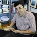 Dr. Jeff Jensen holds a Lake Washington Kokanee sample from 1888. He plans to use the Smithsonian find as a way to compare DNA from any Kokanee-looking fish that might turn up in Lake Washington streams. (Celeste Gracey / Special to the Reporter)