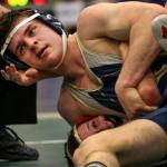 Arlington&rsquo;s Colton Ferro works to pin Kamiakin&rsquo;s Luke Eskelsen in a 195-pound match at the 3A Region 3 Tournament on Feb. 11 at Everett High School. Ferro won 9-6. (Kevin Clark / The Herald)