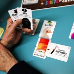 John Cumbow, of Stanwood, lays out his hand while playing the new Bears vs. Babies game at the Arlington Library on Wednesday. (Ian Terry / The Herald)
