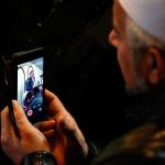 A member at the Evergreen Islamic Institute records Lynnwood Police Chief Tom Davis on his smartphone as he speaks to a standing room only crowd Friday. (Dan Bates / The Herald)