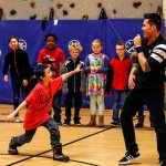 Emerson Elementary School&rsquo;s Adam Thompson demonstrates his skills for professional dancer Jerome Aparis following breakdance lessons that Aparis gave to a group of students. (Dan Bates / The Herald)