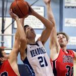 Meadowdale&rsquo;s Daniel Barhoum (center) attempts a shot through the defense of Snohomish&rsquo;s Seth Cavin (left) and Kole Bride (right) during a 3A district play-in game Feb. 10, 2017, at Meadowdale High School in Lynnwood. The Mavericks won 66-54. (Kevin Clark / The Herald)