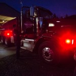Firefighter Cyndy Olson, chaplain and firefighter Joel Johnson and fire Capt. Tim Harper check out the newly repaired firetruck at the station along Highway 530 in Oso on Tuesday, Feb. 21. (Daniella Beccaria / The Herald)