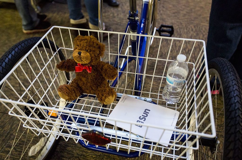 Quinn Schmitz&rsquo;s teddy bear sits in the rear basket of her new tricycle at ATI Physical Therapy in Everett. (Daniella Beccaria / The Herald)