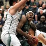 Edmonds-Woodway&rsquo;s Uchenna Acholonu looks to the basket with Shorecrest&rsquo;s Steven Lin (left) and Malcolm Rosier-Butler looking on during a state regional playoff game Feb. 25, 2017, at Bothell High School. Shorecrest won 74-63. (Kevin Clark / The Herald)