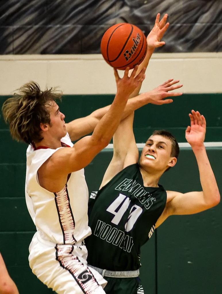 Stanwood&rsquo;s AJ Martinka attempts a shot past Edmonds-Woodway&rsquo;s Ryan Peterson Wednesday night at Henry M. Jackson in Everett on February 15, 2017. (Kevin Clark / The Herald)