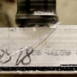 Stock aluminum is squared off during Everett Community College&rsquo;s manufacturing class at Weston High School. (Kevin Clark / The Herald)