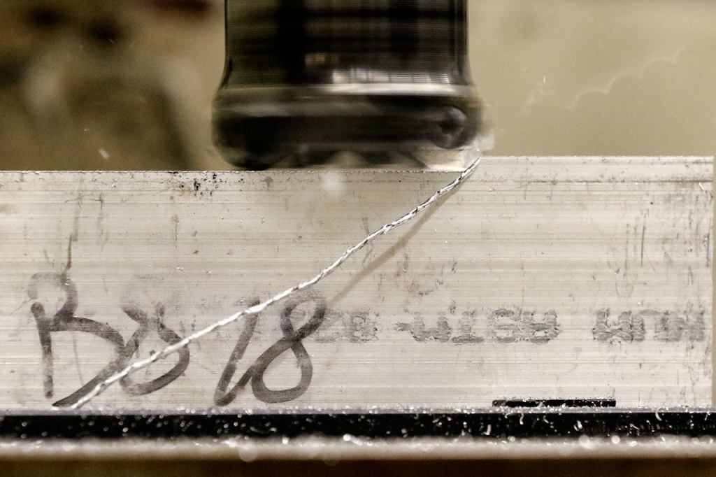 Stock aluminum is squared off during Everett Community College&rsquo;s manufacturing class at Weston High School. (Kevin Clark / The Herald)