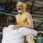 Darrington&rsquo;s Gage Burtenshaw jumps into the arms of his coach, Andy West, after defeating Wilbur-Creston&rsquo;s Joe Peasley in the 160-pound class Saturday during Mat Classic XXIX. (Kevin Clark / The Herald)