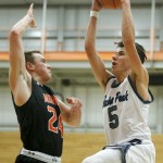 Glacier Peak&rsquo;s Justin Purcell (right) goes up for a shot as Monroe&rsquo;s Justin Folz defends during the Class 4A District 1 boys basketball championship game at Everett Community College on Thursday, Feb. 16. (Ian Terry / The Herald)