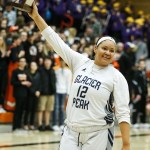 Glacier Peak&rsquo;s Kayla Watkins hoists the Class 4A District 1 girls basketball championship game trophy after defeating Lake Stevens at Everett Community College on Thursday, Feb. 16. (Ian Terry / The Herald)