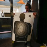 Marlene Wing, of Marysville, looks over her target following a shooting session with other members of the Snohomish County chapter of The Well Armed Woman at the Norpoint Shooting Center in Arlington on Saturday, Feb. 4. (Ian Terry / The Herald)