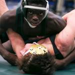 Edmonds-Woodway&rsquo;s Salihou Fatty looks to the clock in the midst of a 132-pound match with Oak Harbor&rsquo;s Blake McBride at the 3A Region 3 Tournament on Feb. 11 at Everett High School. Fatty won 10-5. (Kevin Clark / The Herald)