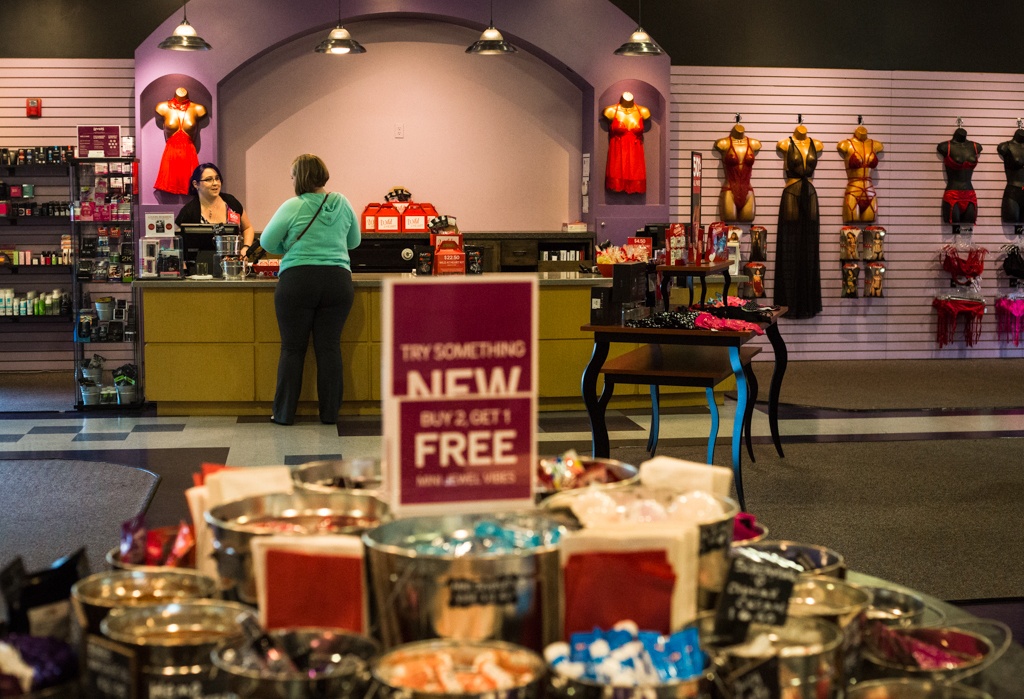 A sales associate helps customer Katie Garza at Lovers on Tuesday, Feb. 7 in Everett, Wa. Lovers offers lingerie, sex toys, accessories and many more items geared toward sexual wellness and expression. (Daniella Beccaria / The Herald)