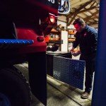 Oso chaplain and firefighter Joel Johnson inspects the newly repaired firetruck at the station on Highway 530 in Oso on Tuesday. (Daniella Beccaria / The Herald)