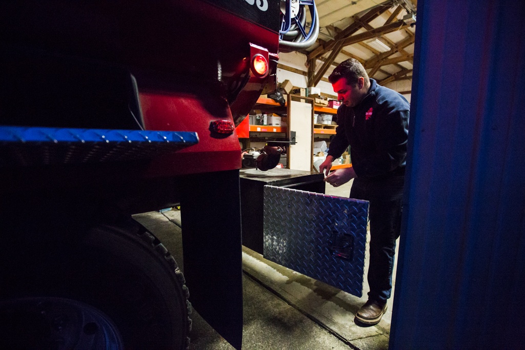 Oso chaplain and firefighter Joel Johnson inspects the newly repaired firetruck at the station on Highway 530 in Oso on Tuesday. (Daniella Beccaria / The Herald)