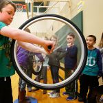 First-grader Sawyer Jensen demonstrates how a gyroscope works for his classmates Thursday during Pacific Science Center&rsquo;s Science on Wheels event at Highland Elementary School in Lake Stevens. (Dan Bates / The Herald)