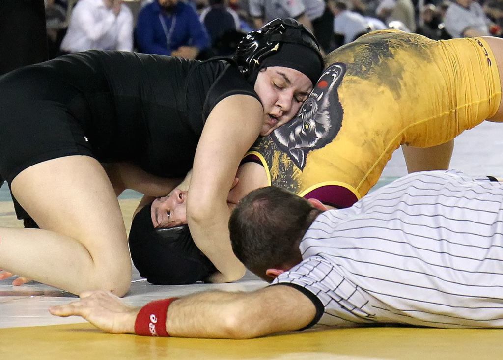 Kamiak&rsquo;s Ally DeLa Cruz works to pin Sequim&rsquo;s Alma Mendoza in the 155-pound weight class Saturday during Mat Classic XXIX on Saturday. (Kevin Clark / The Herald)