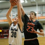 Glacier Peak&rsquo;s Bobby Martin (30) goes up for a shot as Monroe&rsquo;s Trenton Newhouse (23) defends during the Class 4A District 1 boys basketball championship game at Everett Community College on Thursday, Feb. 16. (Ian Terry / The Herald)