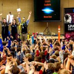 Entertaining educators from Pacific Science Center, Janice Crew (left) Kate Wellens and Mike Sweeney get a lot of small hands at the end of their presentation to all the second-graders at Highland Elementary in Lake Stevens on Thursday. (Dan Bates / The Herald)