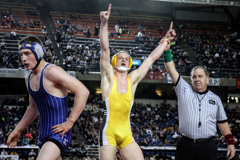 Darrington&rsquo;s Gage Burtenshaw celebrates after defeating Wilbur-Creston&rsquo;s Joe Peasleym (left) in the 160-pound class Saturday during Mat Classic in Tacoma. (Kevin Clark / The Herald)