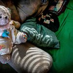 A cuddly stuffed bear in a clown suit sits on the arm of the couch where Gordon &ldquo;Casey&rdquo; Powell Jr. slept for five years at his sister&rsquo;s home in Centralia after she became his legal guardian. The sofa has a permanent trough where her brother slept. (Dan Bates / The Herald)