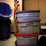 Containers of props, which could just as easily be marked &ldquo;curiosity encouraged,&rdquo; sit near the staging area where the Science on Wheels program is setting up a space show at Highland Elementary School in Lake Stevens on Thursday. (Dan Bates / The Herald)