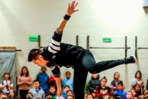 Break dancer Jerome Aparis dazzles students with mid-air moves Feb. 3 at Emerson Elementary School where 21 languages are spoken. (Dan Bates / The Herald)