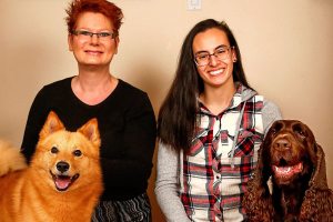 Everett&rsquo;s Wendy Whiteley (left) with Zoom, her Finnish Spitz, gets together at her Lowell neighborhood home with Shahntae Martinez and her Field Spaniel, Hudson. Martinez, a 17-year-old Sequoia High School student, and Whiteley will compete with their dogs next week at the Westminster Kennel Club Dog Show in New York City. (Dan Bates / The Herald)