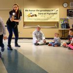 In a game demonstrating the speed of light in front of all her K thu 2 classmates, Highland Elementary first-grader, Ava Aguero tries her hardest to outrun light from a flashlight held by Janice Crew of the Pacific Science Center during a &ldquo;space&rdquo; presentation Thursday at the school. (Dan Bates / The Herald)