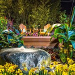 The 2016 display garden &ldquo;A World Away on the Na Pali Coast&rdquo; by Plantswoman Design, Bainbridge Island, showcases Hawaii&rsquo;s wilderness and rainforest. The tropical setting has a deck constructed using sustainable cedar, Japanese soaking tub and fragrant foliage. A fountain created from native rock is both polished by man and rough-hewn by nature. The bamboo forest in the back of the garden reveals fresh viewpoints that encourage further exploration. (Northwest Flower & Garden Show)