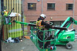 Construction workers at WhidbeyHealth Medical Center build the corridor that connects the old hospital to the $50 million addition. The 60,000-square-foot wing features 39 private patient rooms and many design elements for infection control and privacy.