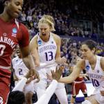 Washington&rsquo;s Kelsey Plum (10) and Katie Collier (13) reach to help Chantel Osahor to her feet after she was fouled during the first half Monday&rsquo;s game in Seattle. (AP Photo/Elaine Thompson)