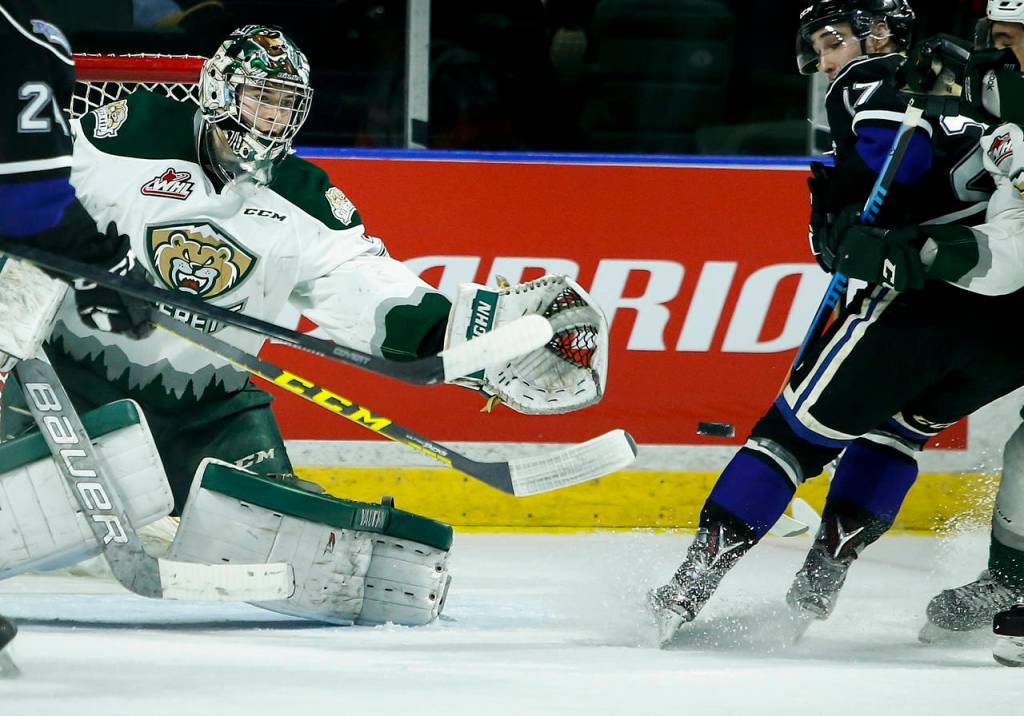 Silvertips goalie Carter Hart (center) eyes the puck during Game 1 of the opening-round playoff series against the Royals on March 24, 2017, at Xfinity Arena in Everett. (Ian Terry / The Herald)