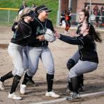 Jackson players Mollie Hickman (right) and Sam Mutolo (top right) celebrate with pitcher Iyanla Pennington (center left) and shortstop Kristina Day after Day made a catch and threw to first base for a double play to complete their victory over Monroe on March 31, 2017, at Jackson High School. (Ian Terry / The Herald)