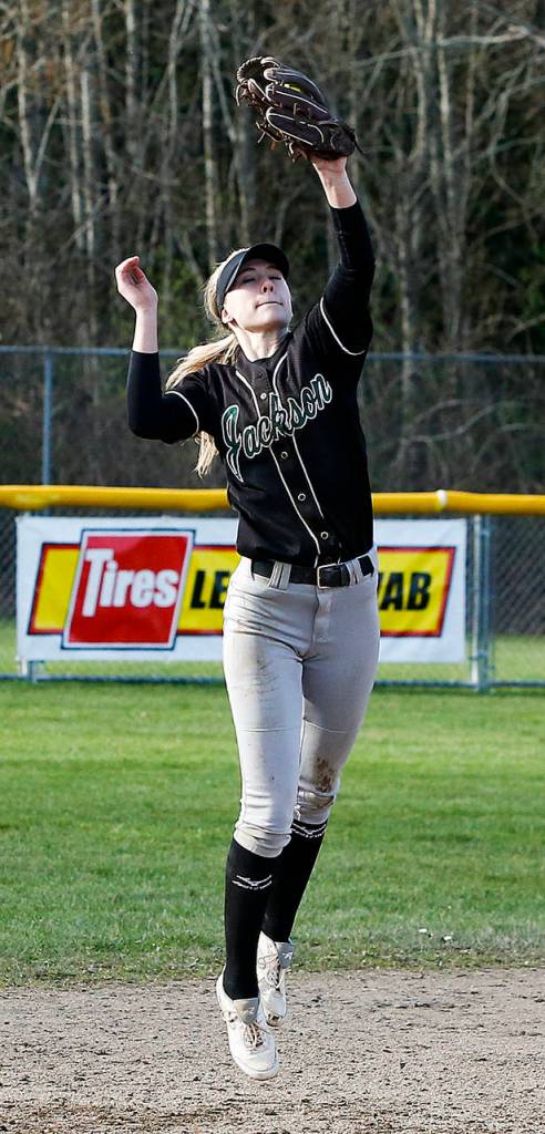 Jackson shortstop Kristina Day makes a leaping catch before throwing to first base for a double play in the seventh inning of a game against Monroe on March 31, 2017, at Jackson High School. (Ian Terry / The Herald)