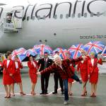 Richard Branson (center), founder of Virgin Atlantic and the Virgin Group, poses for a photo after he arrived on a flight from London to Seattle on Monday, March 27, at Seattle-Tacoma International Airport. (AP Photo/Ted S. Warren)