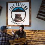 Julia Turner and her father, Ed, toast as they sample the beer and cider at Lake Stevens Brewing Co., the first brewery in the city. (Andy Bronson / The Herald)