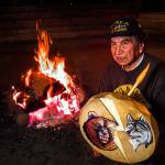 In the Tulalip Tribes&rsquo; sacred long house on Tulalip Bay in April 1999, Raymond Moses prepares a warm fire before meeting with youngsters from Pinewood Elementary School in Marysville. (Dan Bates / Herald file)
