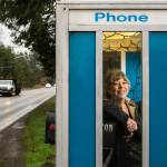 JoAnn Johnston stands in a pay phone booth that is now her mailbox on 180th Street SE in Snohomish. (Andy Bronson / The Herald)